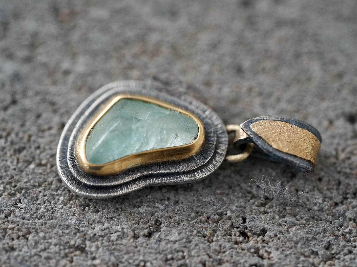 Organic quamarine and gold pendant