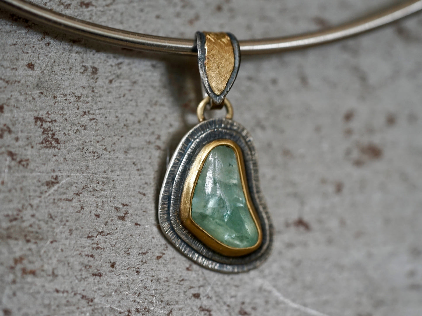 Organic quamarine and gold pendant