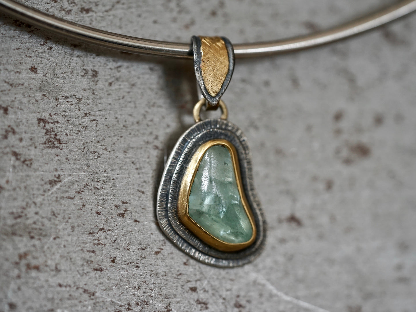 Organic quamarine and gold pendant