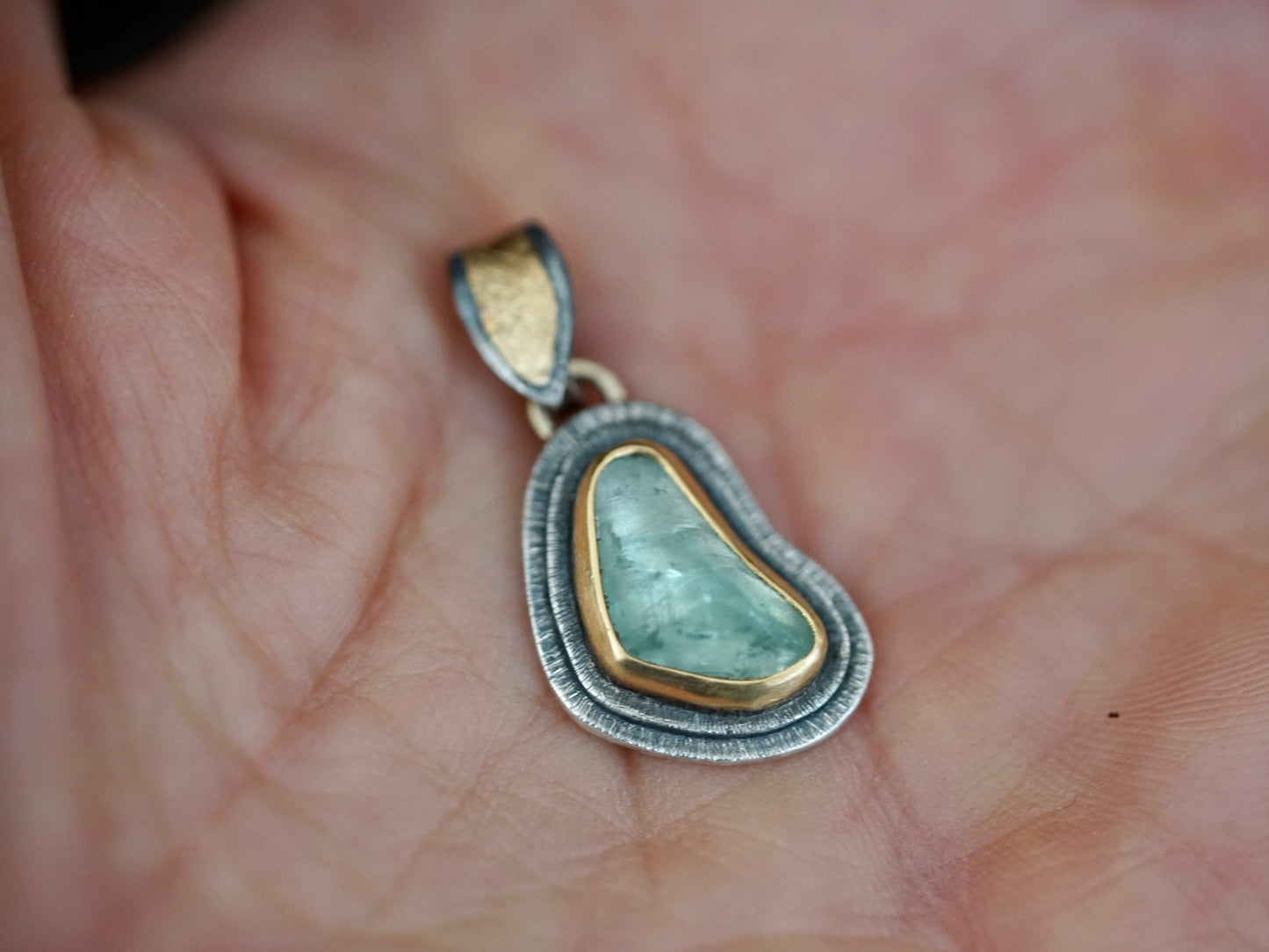 Organic quamarine and gold pendant