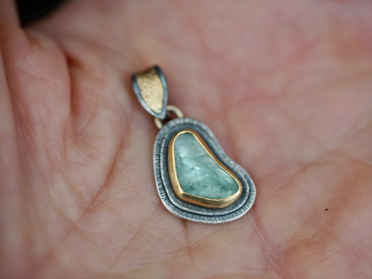 Organic aquamarine and gold pendant