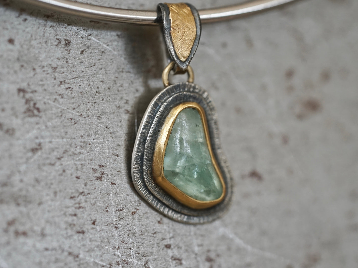 Organic quamarine and gold pendant