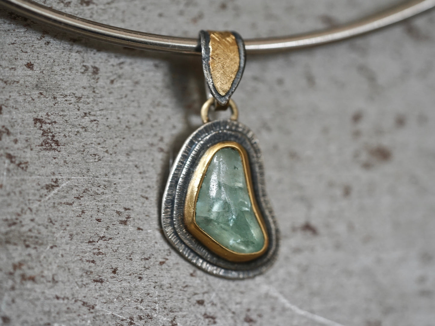 Organic quamarine and gold pendant