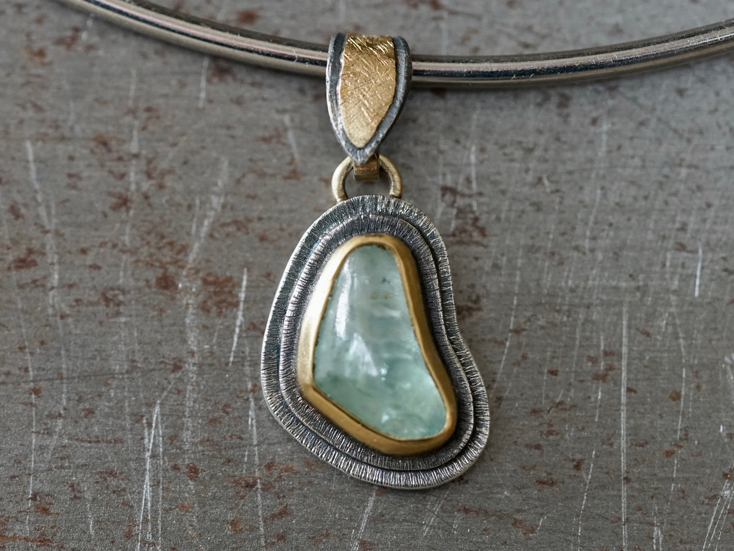 Organic quamarine and gold pendant