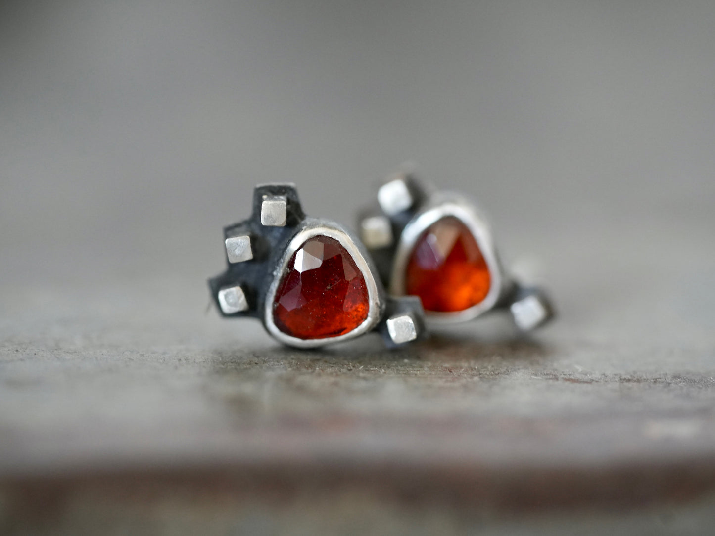 Garnet post earrings embellished with small silver cubes