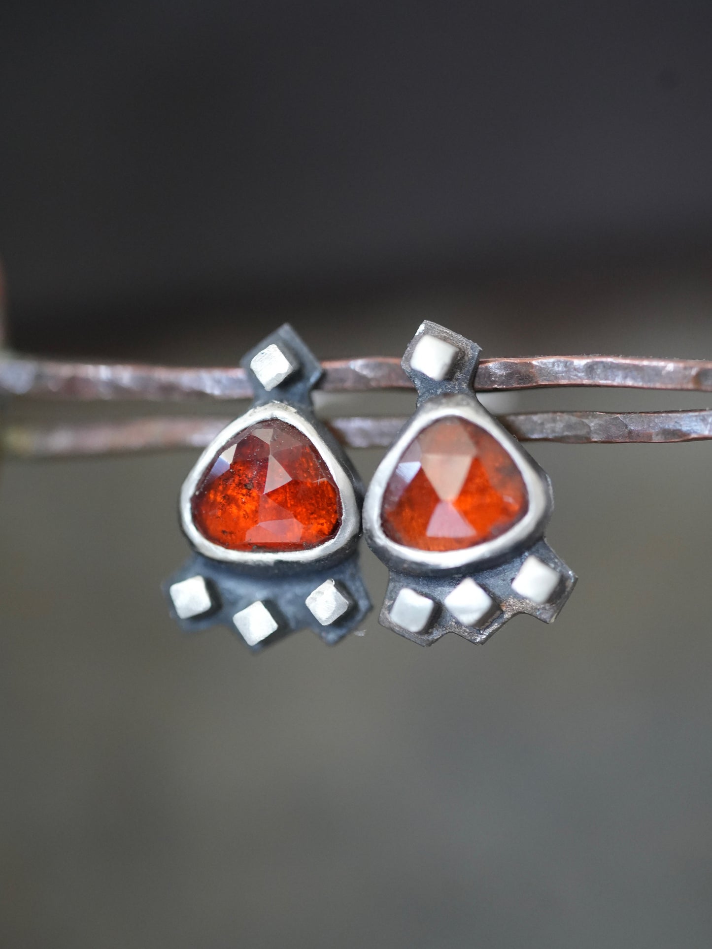 Garnet post earrings embellished with small silver cubes