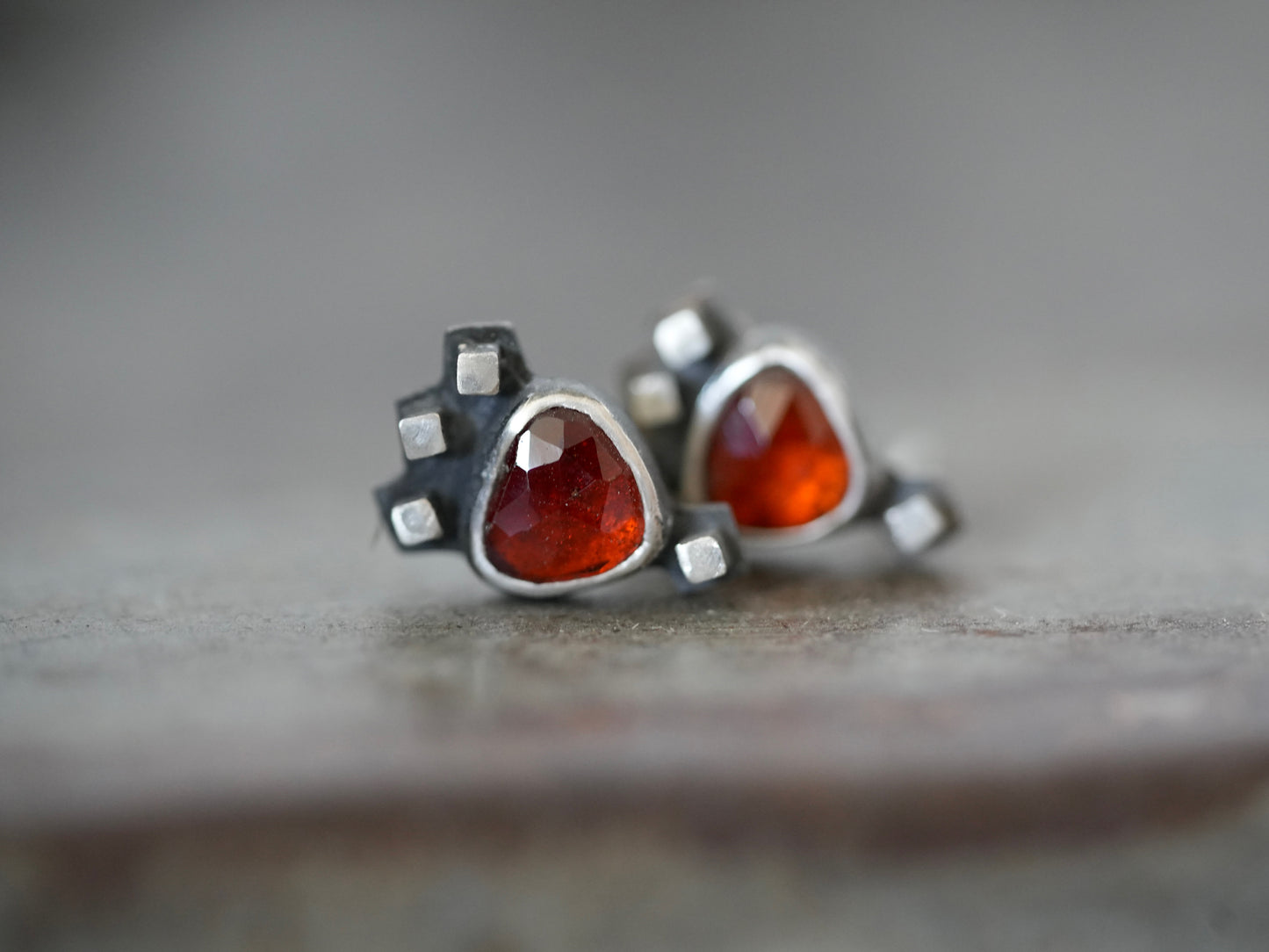 Garnet post earrings embellished with small silver cubes