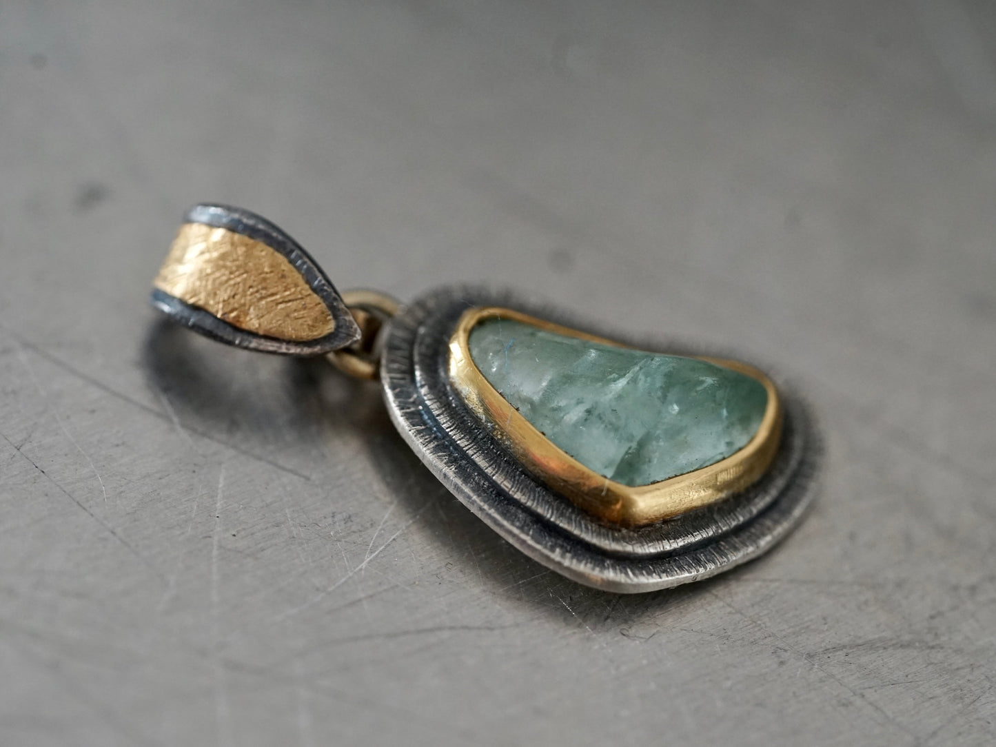 Organic aquamarine and gold pendant