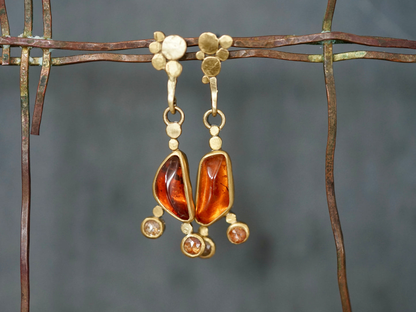 Exquisite, asymmetrical hessonite garnet and diamond drop earrings