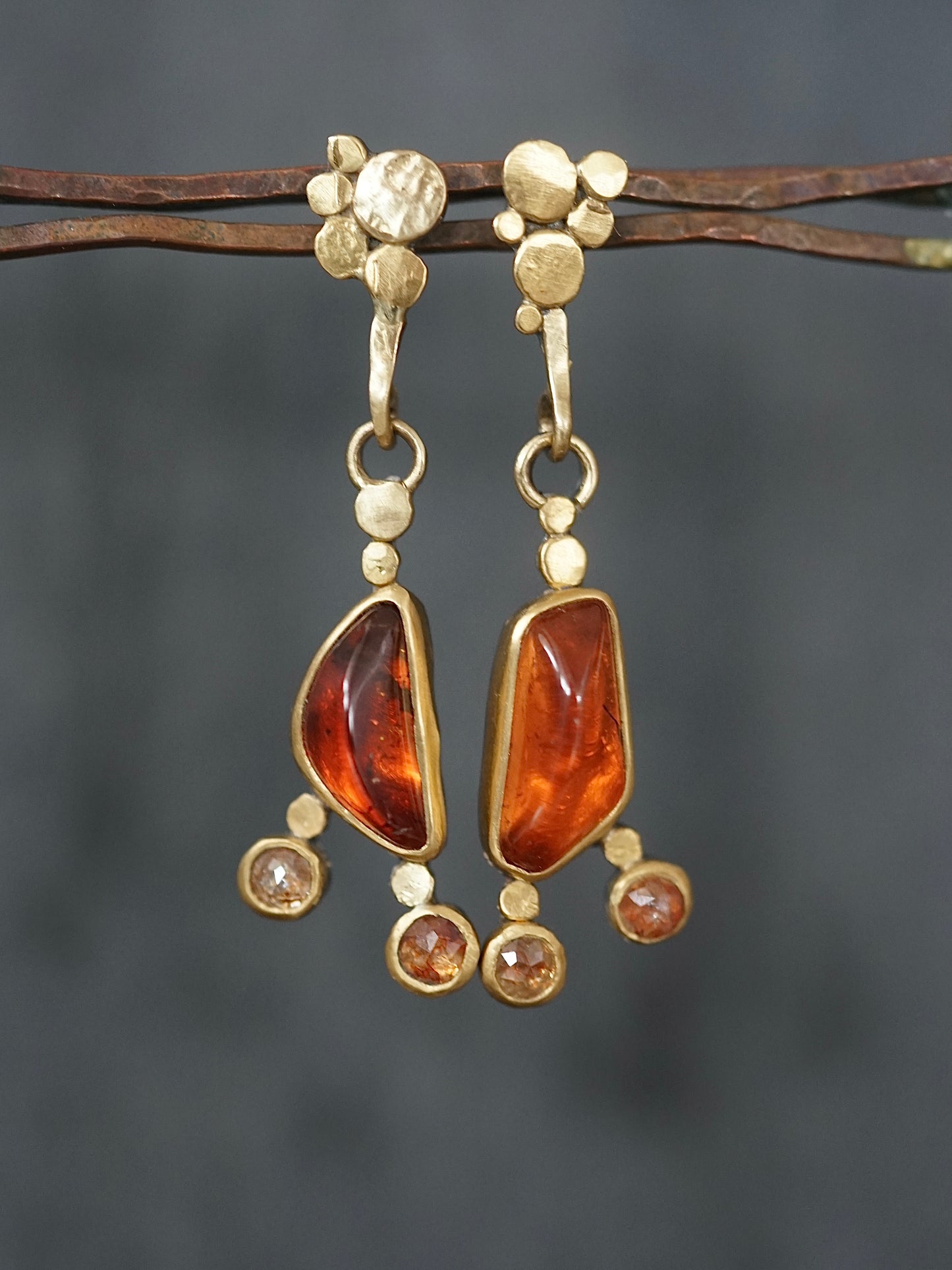 Exquisite, asymmetrical hessonite garnet and diamond drop earrings