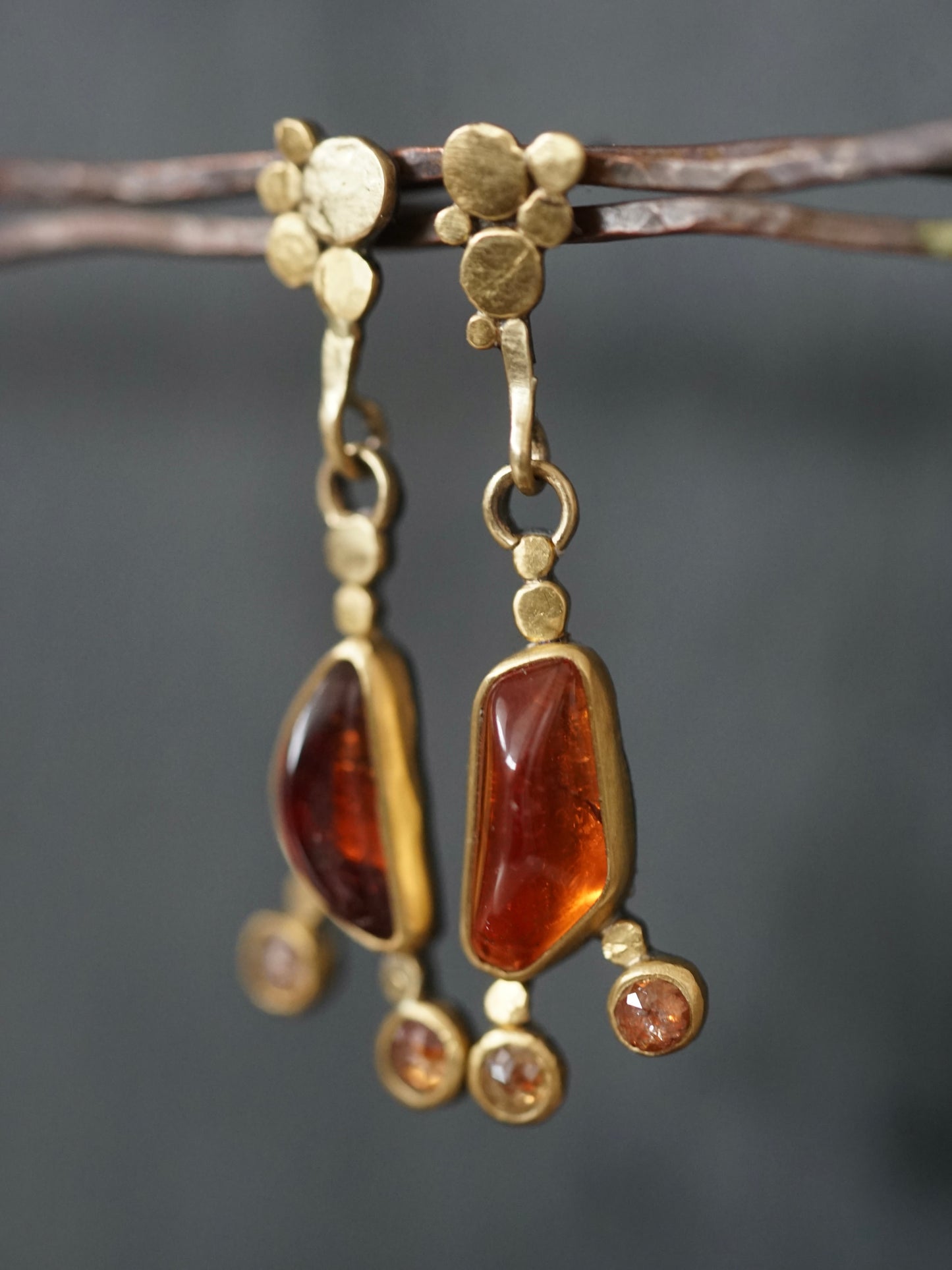 Exquisite, asymmetrical hessonite garnet and diamond drop earrings