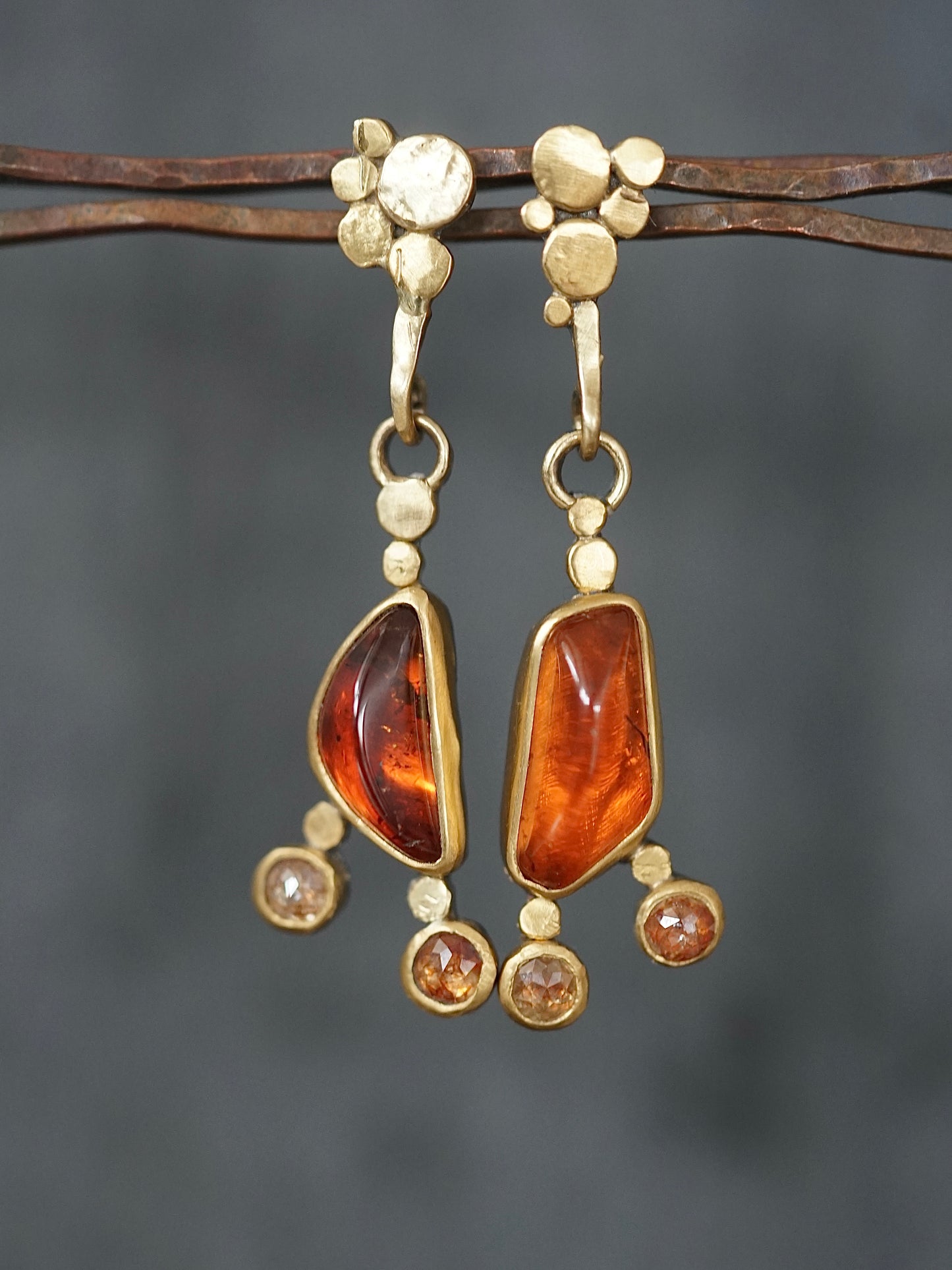 Exquisite, asymmetrical hessonite garnet and diamond drop earrings