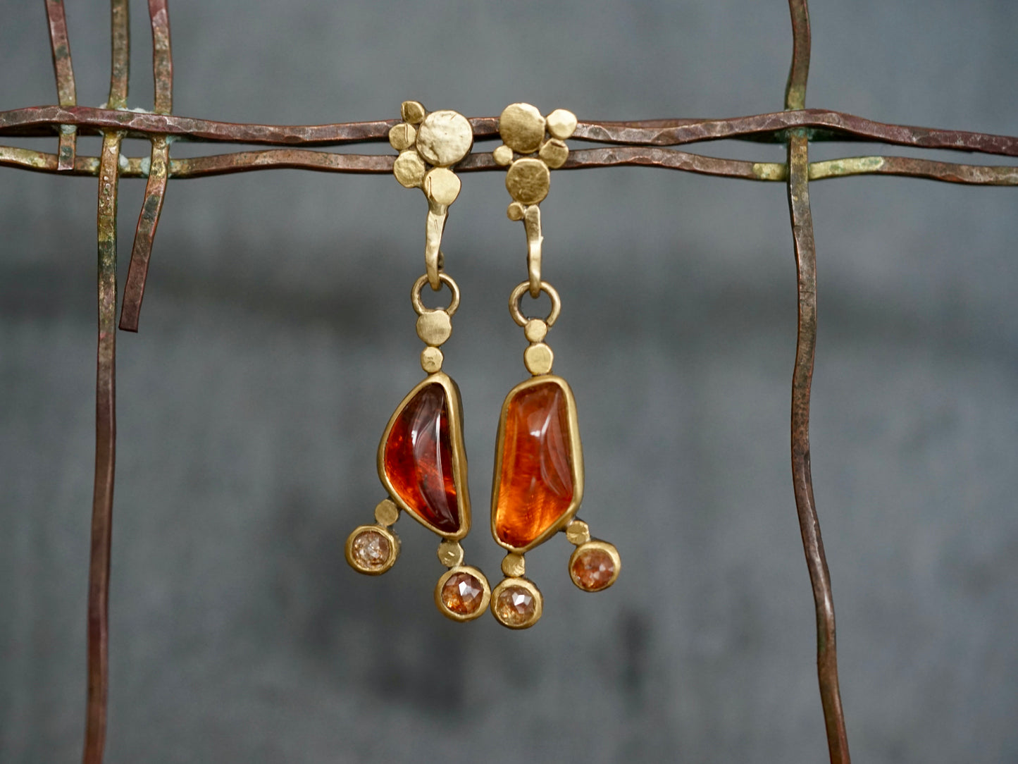 Exquisite, asymmetrical hessonite garnet and diamond drop earrings