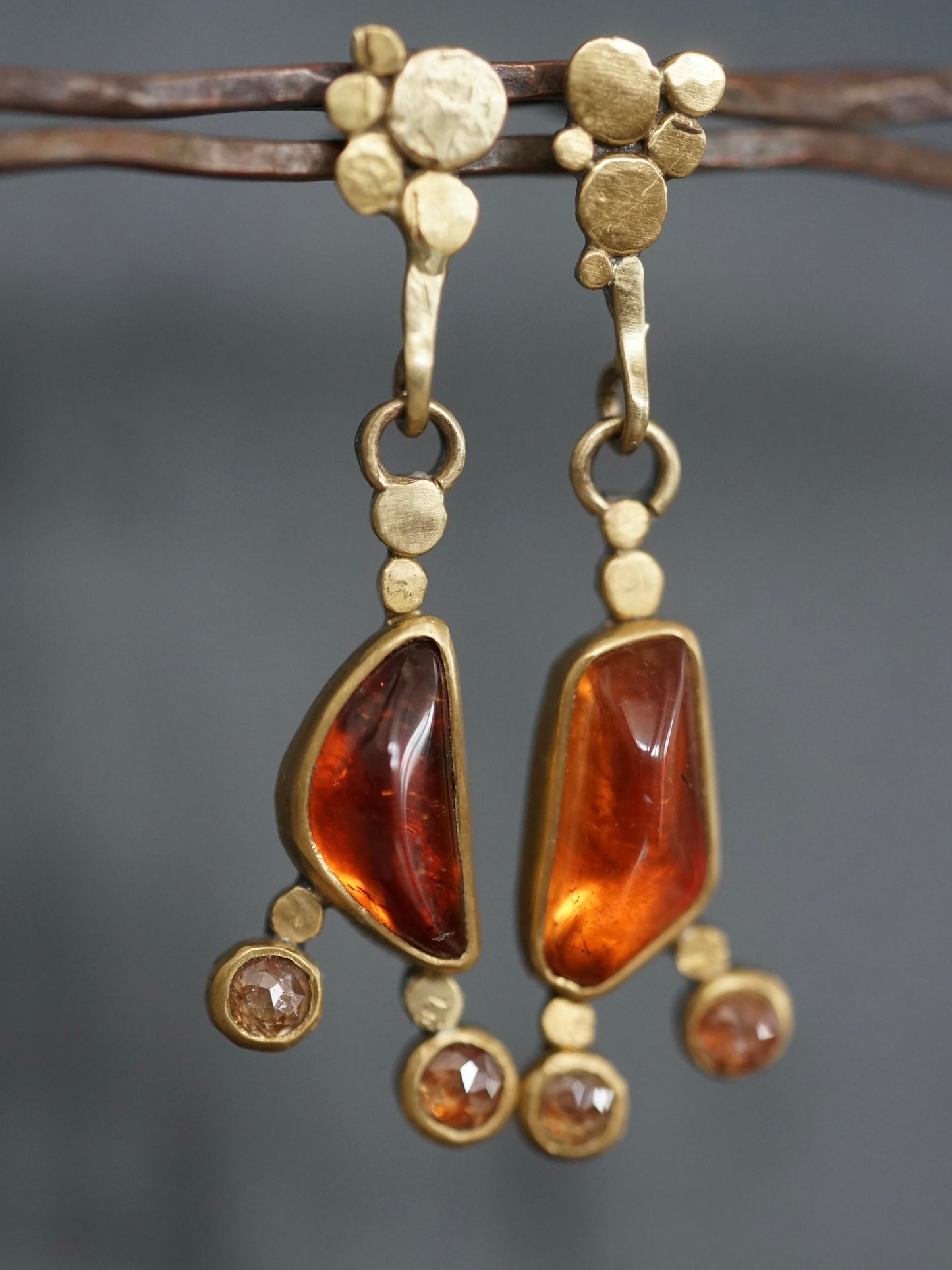 Exquisite, asymmetrical hessonite garnet and diamond drop earrings